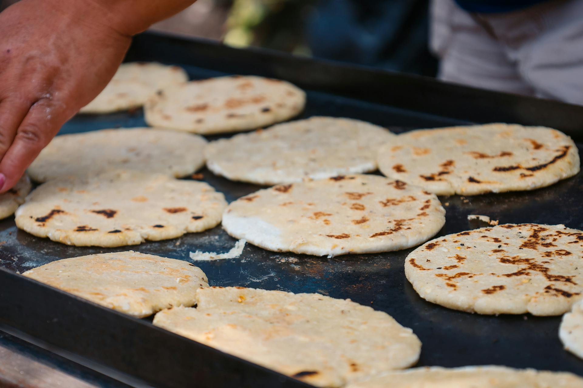 Colorful display of various Colombian foods like arepas and empanadas
